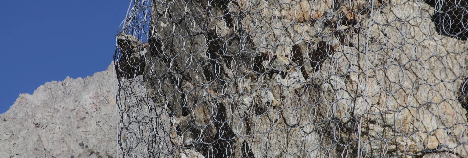 Hexagonal netting system and ring net system are used together for slope protection.