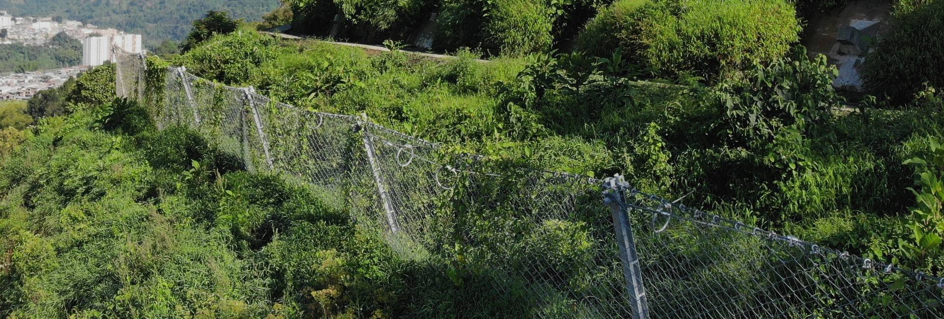 Reinforced rockcon avalanche barrier is established at the middle of the mountain slope.